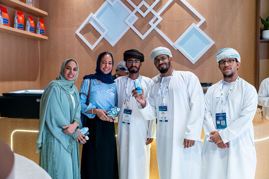 The OURWATER team and partners holding carton bottles